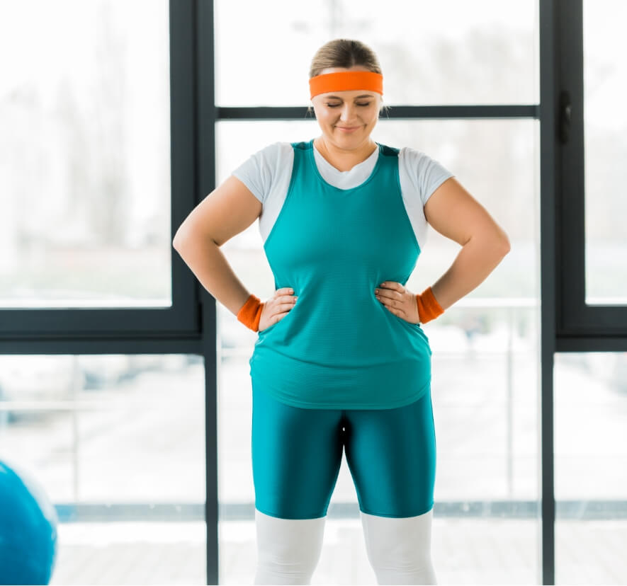 plus-size-woman-standing-and-smiling-near-fitness-2024-11-10-13-25-10-utc